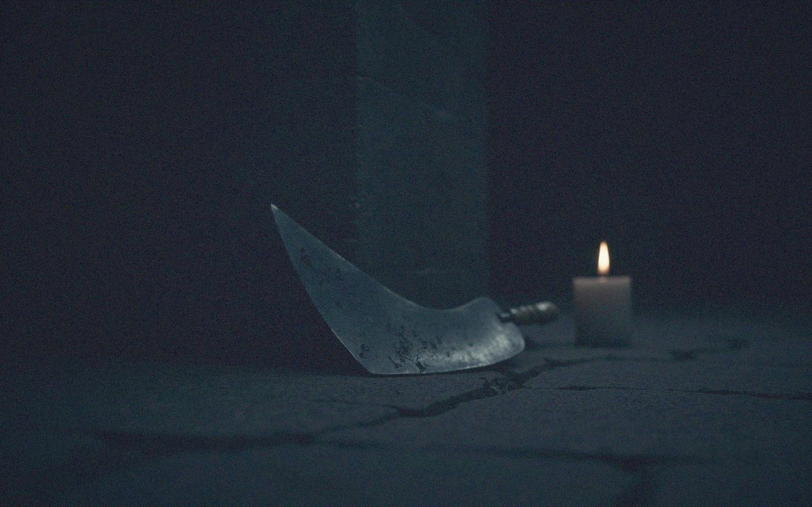 Candlelit still life evoking the film's villain
